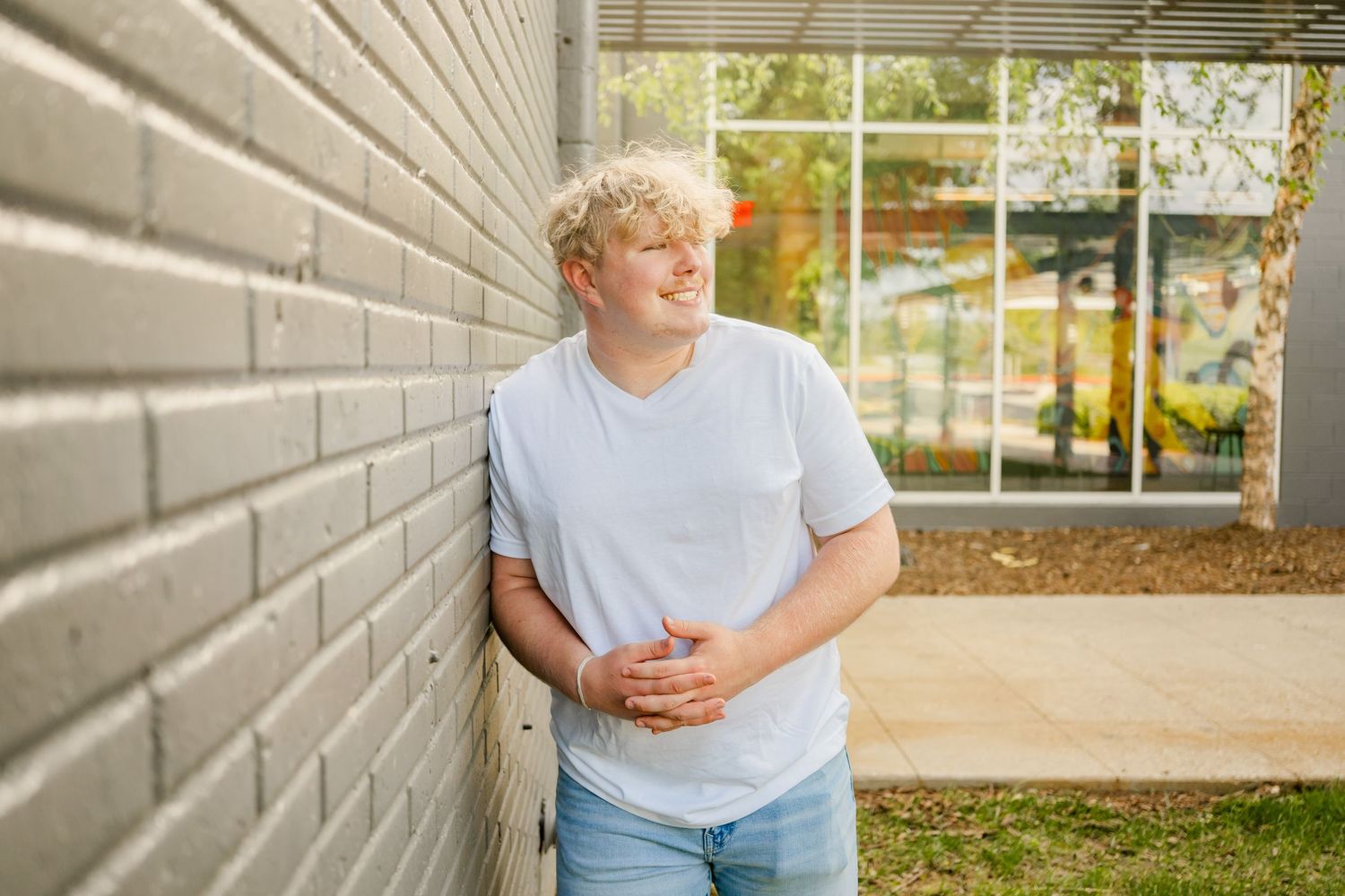 boy Senior Photography portrait session in bentonville arkansas at 8th street market by best photographer in bentonville arkansas
