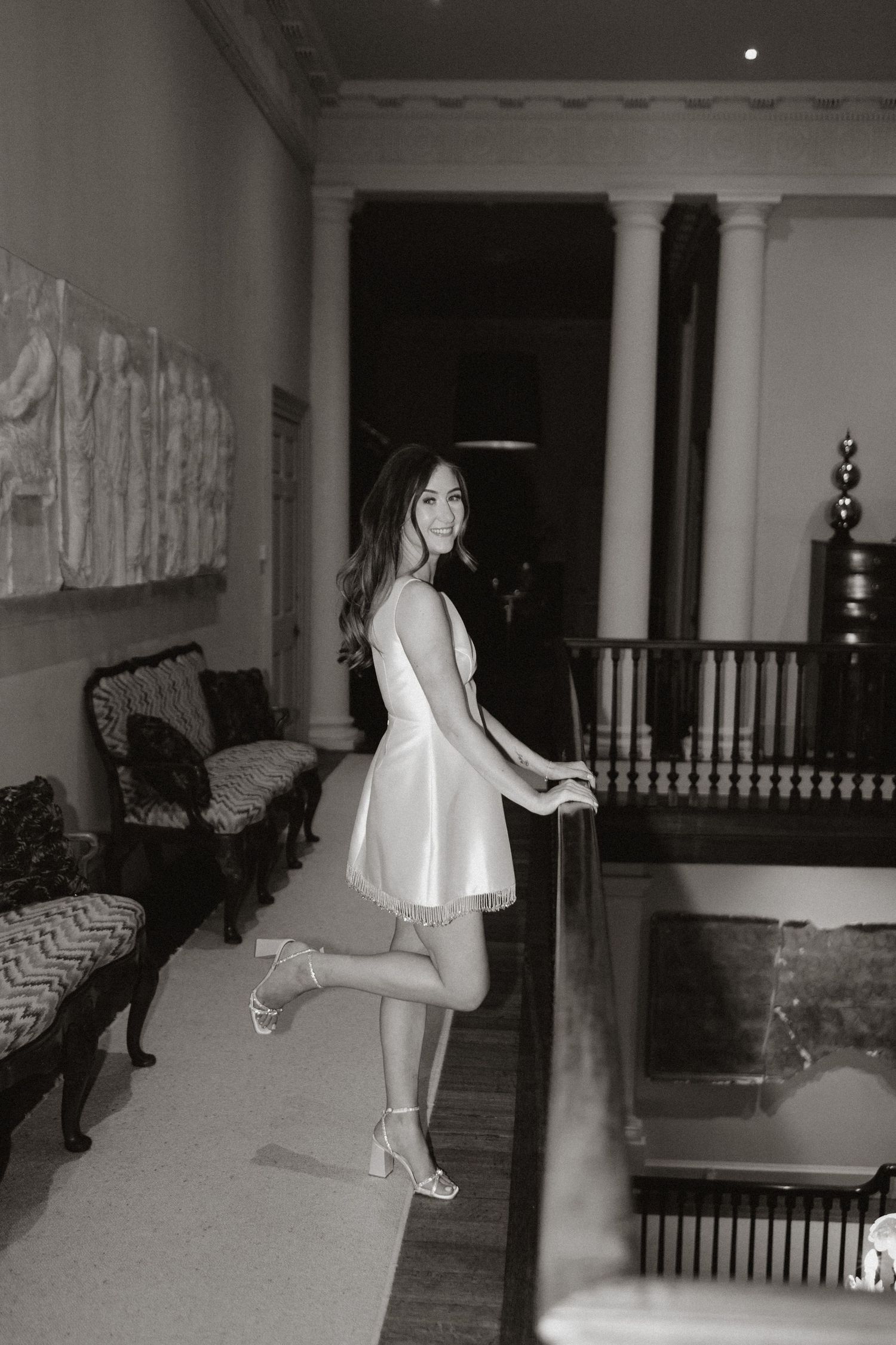 Sequence of black and white security camera images showing someone walking through an outdoor porch area at night.