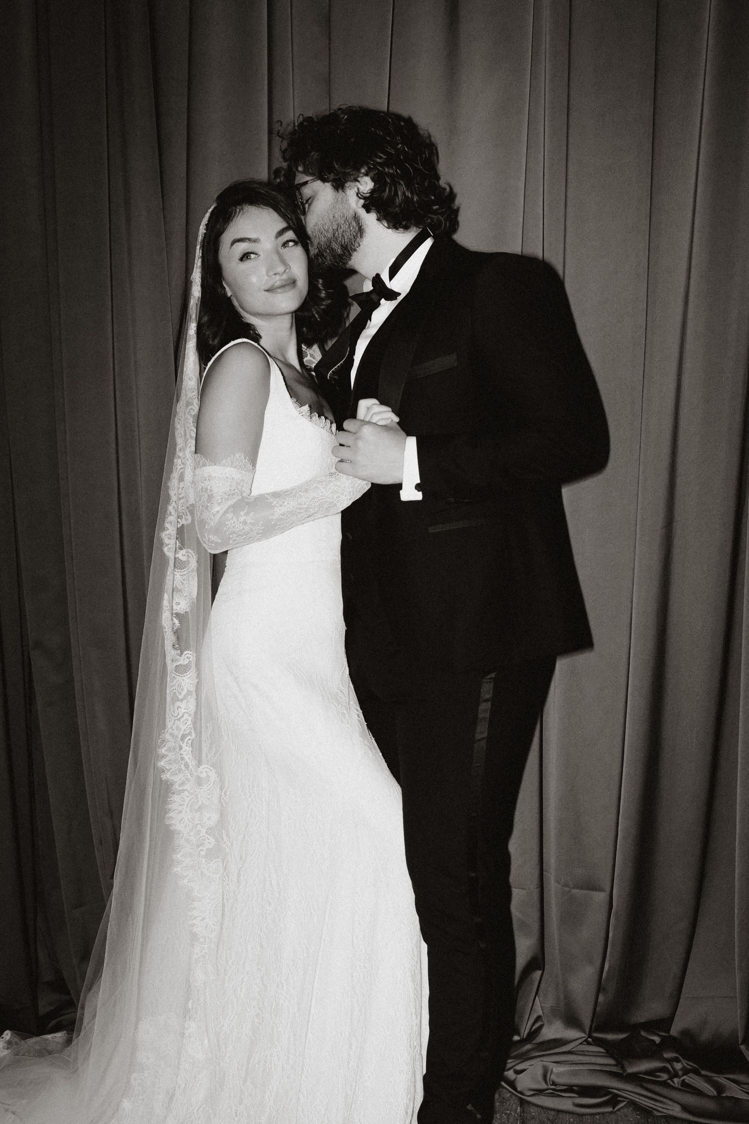 A romantic black and white wedding photo series showing tender moments between newlyweds in formal attire.
