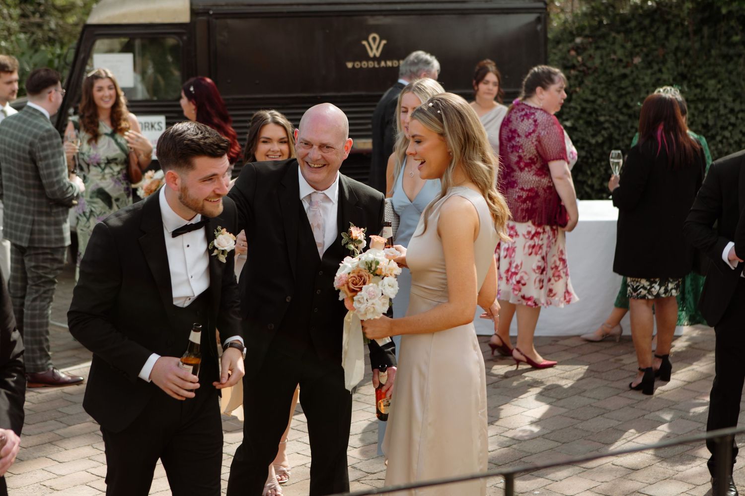Wedding guests mingle and socialize during an outdoor cocktail reception at an elegant venue.