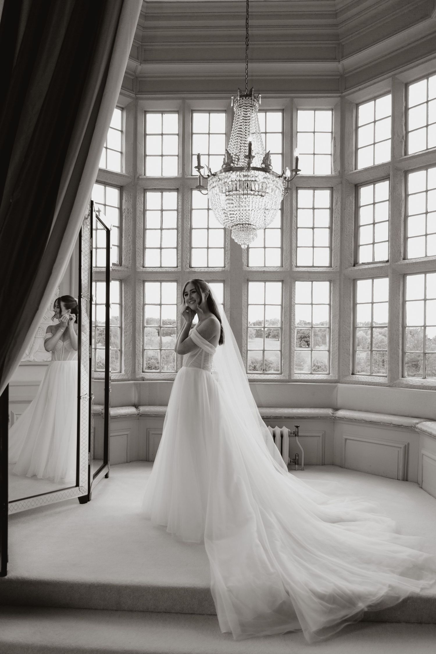 Black and white photo series captures a flowing white wedding gown as it moves gracefully in an elegant sunlit room.