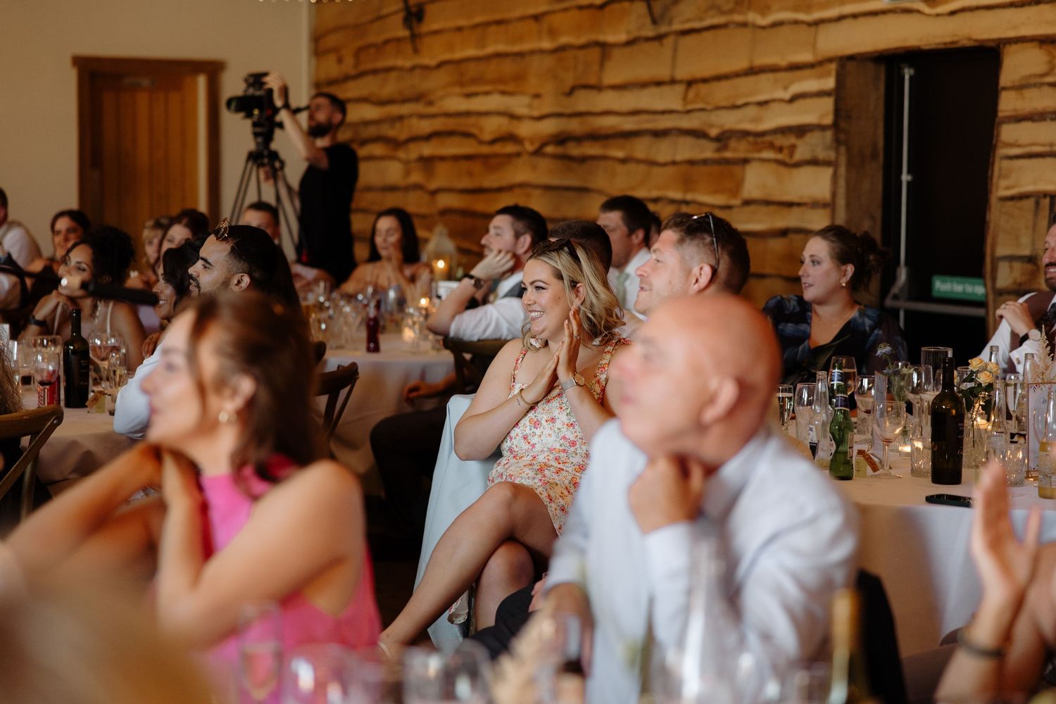 Wedding guests dance and celebrate together on a lively dance floor during an indoor reception celebration.