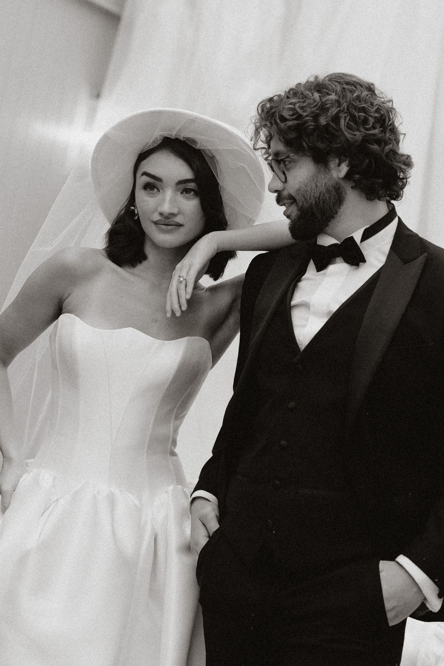 A romantic black and white photo series of a couple in wedding attire sharing intimate moments together.