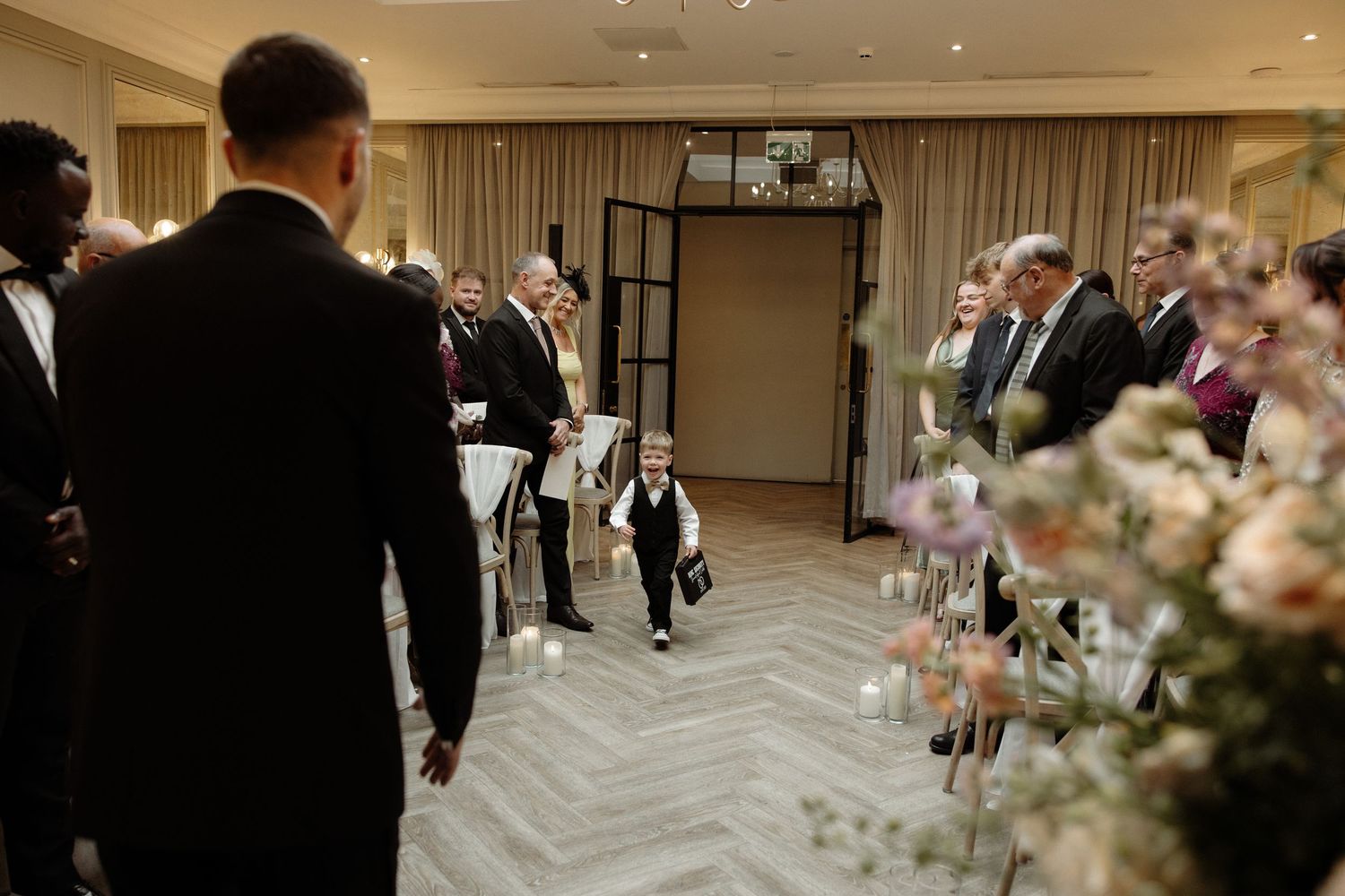 A luxurious wedding reception hall decorated with elegant floral centerpieces and soft lighting for an evening celebration.