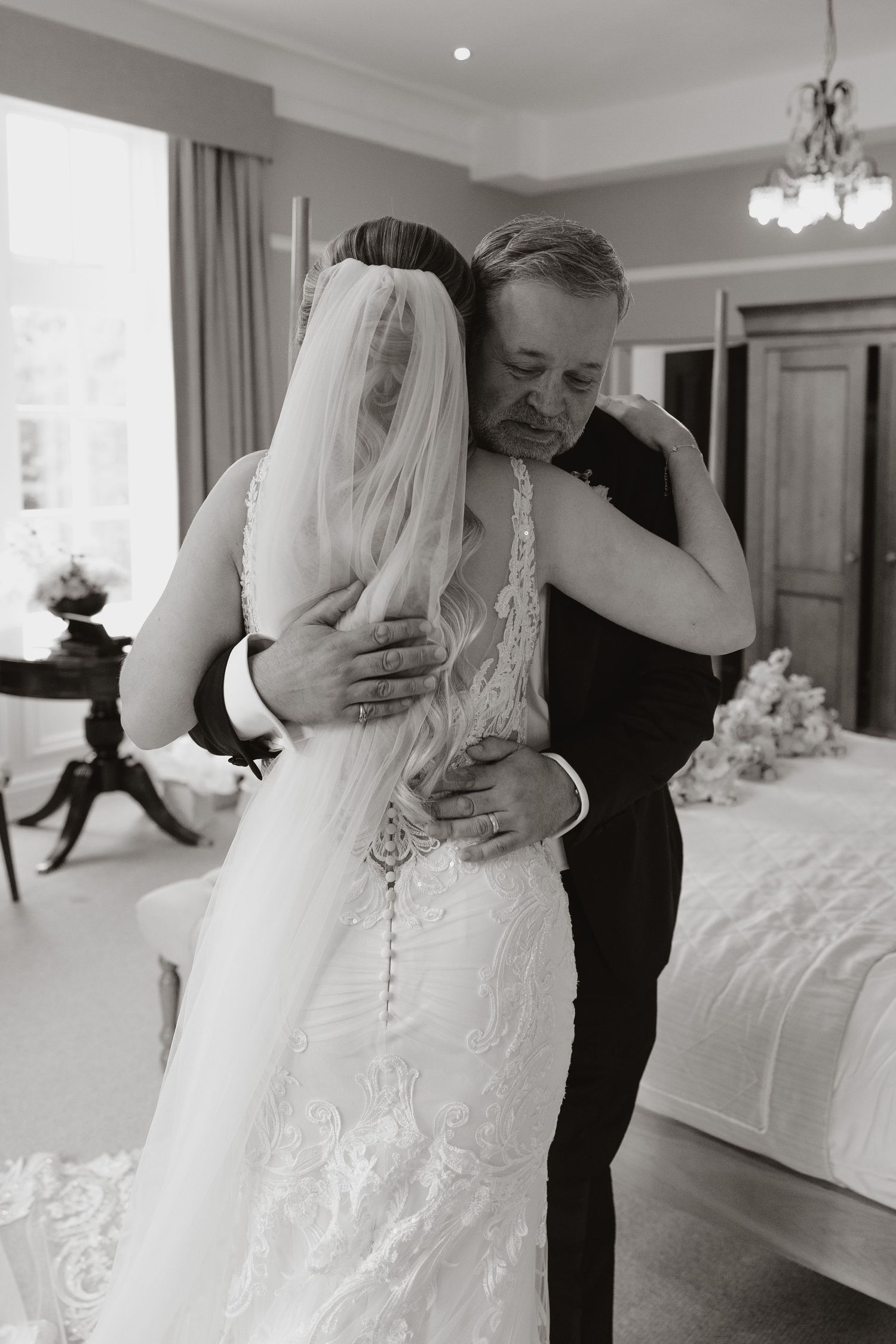 A romantic black and white wedding photo series showing intimate moments between a couple in formal attire.