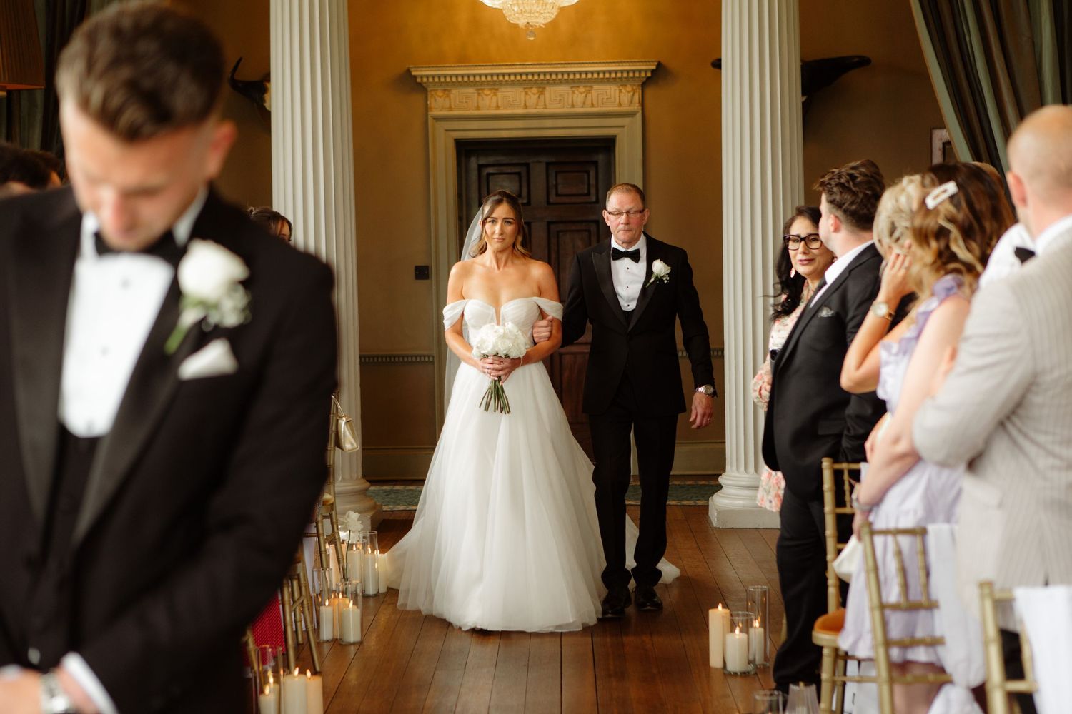A collage of wedding moments in an elegant venue with columns and chandeliers showing formal attire and celebrations.