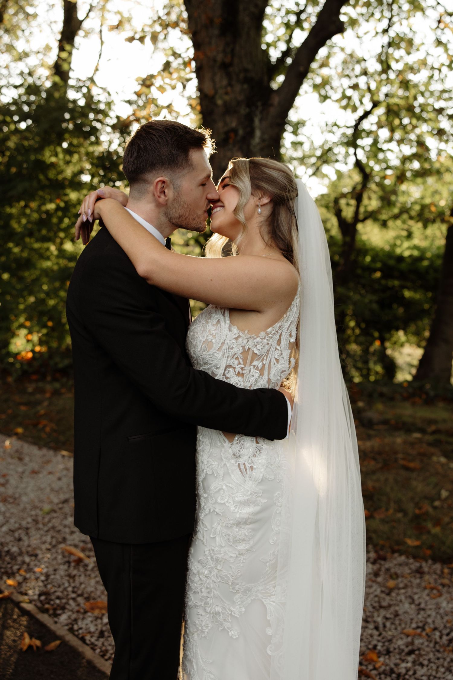 Intimate wedding portraits captured in sequence showing tender moments between newlyweds in a wooded setting.