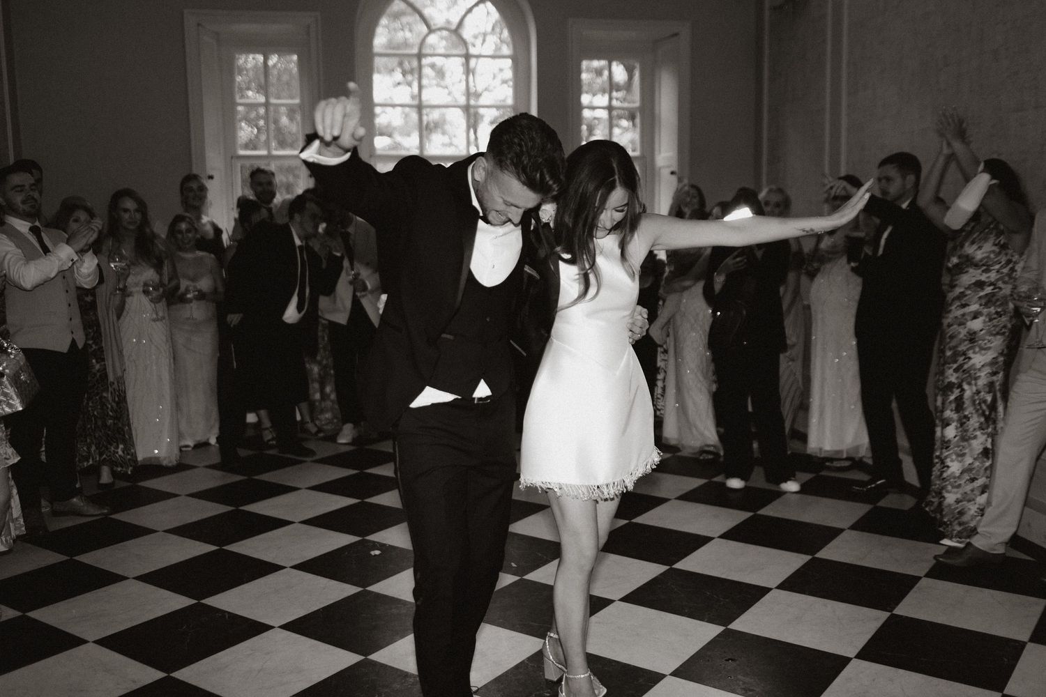A sepia-toned sequence of black and white photographs showing a couple's first dance at a wedding reception.