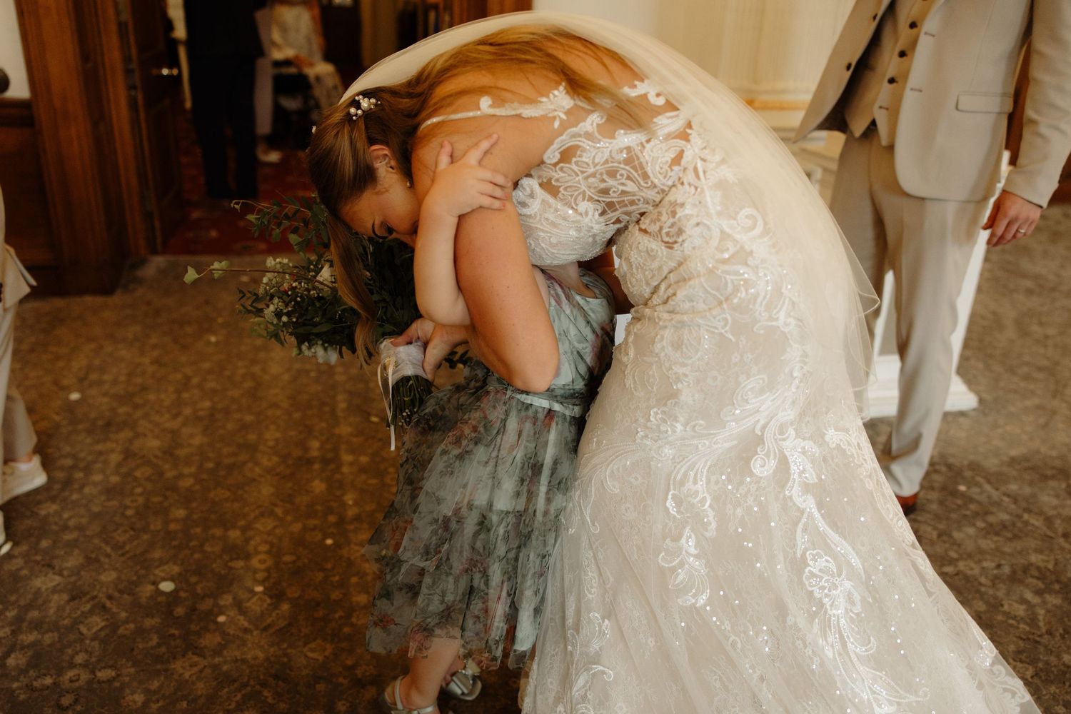 A bride and groom share their first dance in an elegant ballroom during their wedding reception.