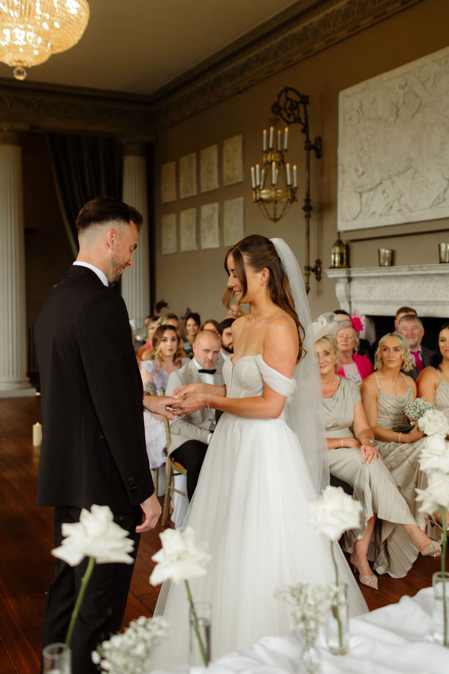 Joyful wedding reception celebration in an elegant ballroom with guests and decor.