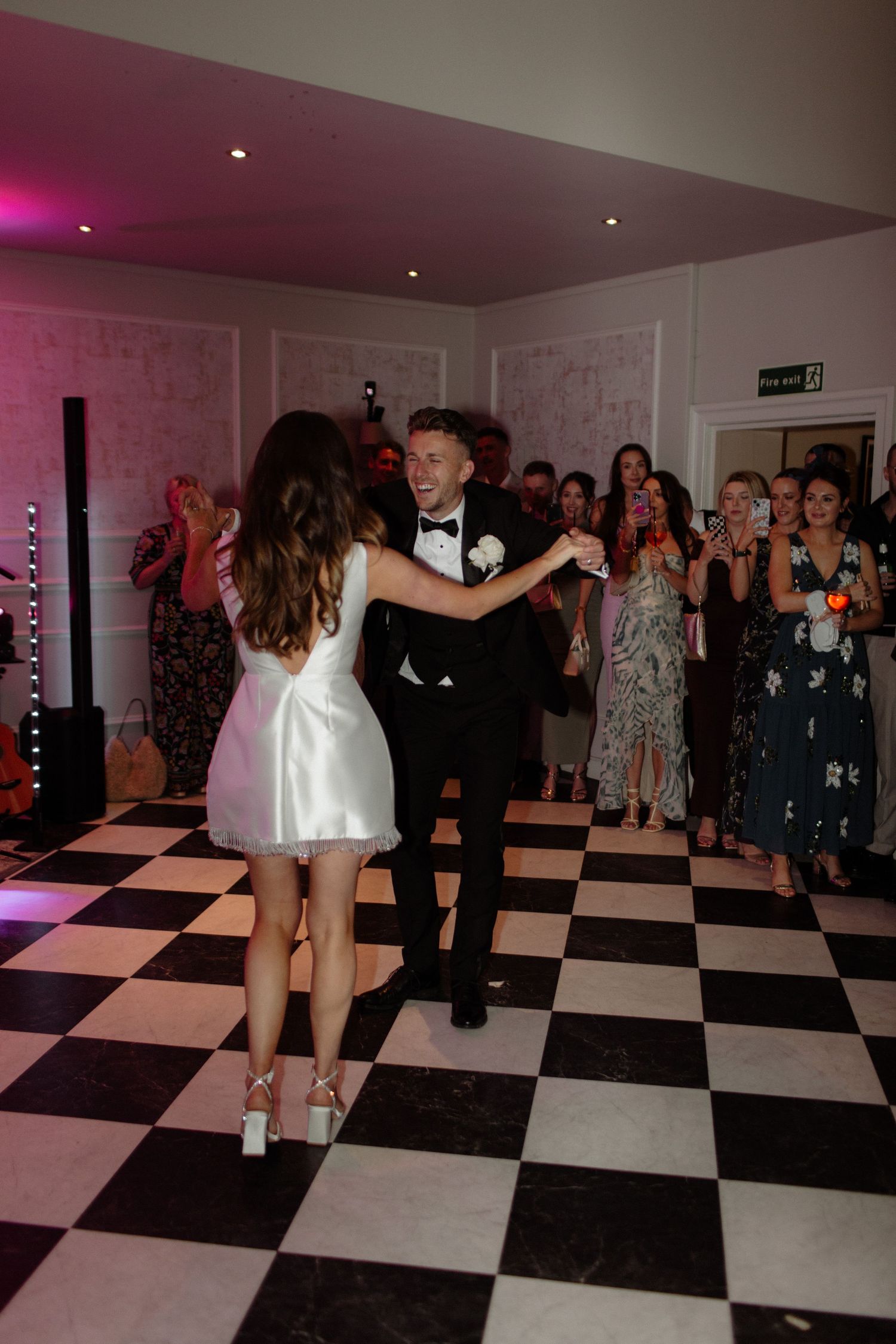 A sequence of dance moves captured on a black and white checkered dance floor during a party celebration.