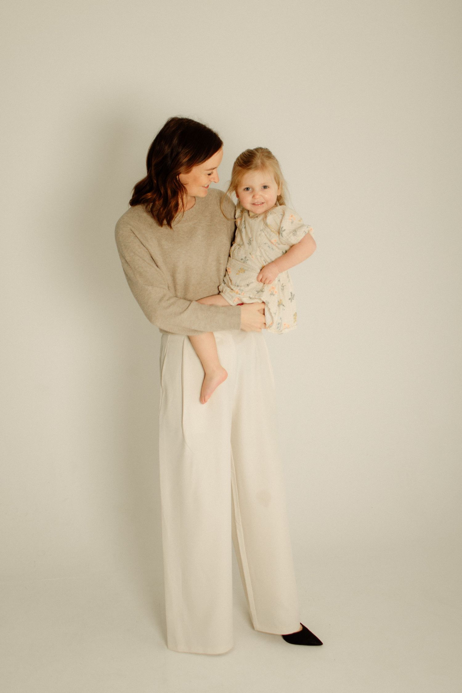 Artistic portrait series in neutral tones against plain background.