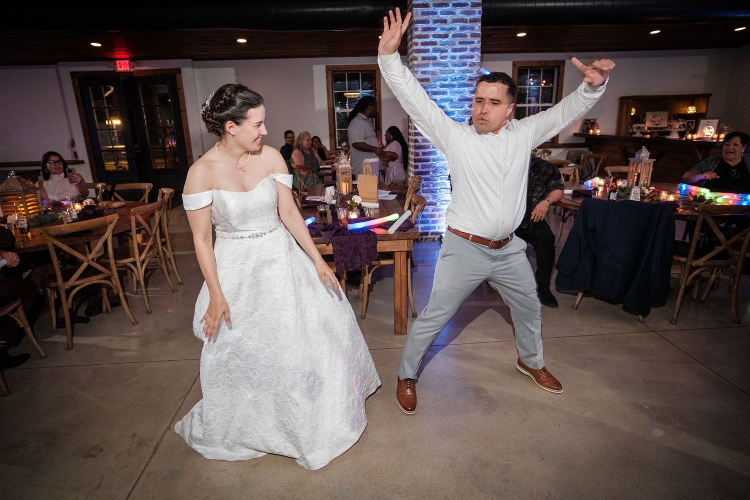 Bride and groom share a fun, energetic first dance at their wedding reception.