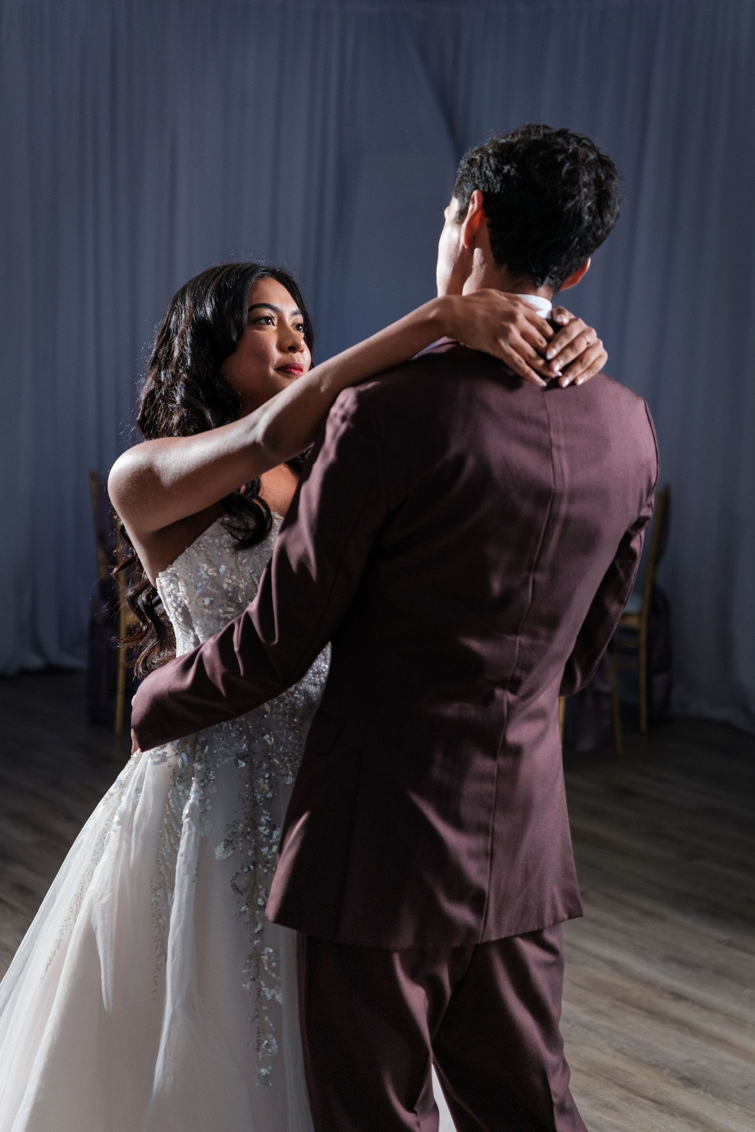A sequence of five wedding dance photos showing a couple performing a romantic dip move on a wooden dance floor.