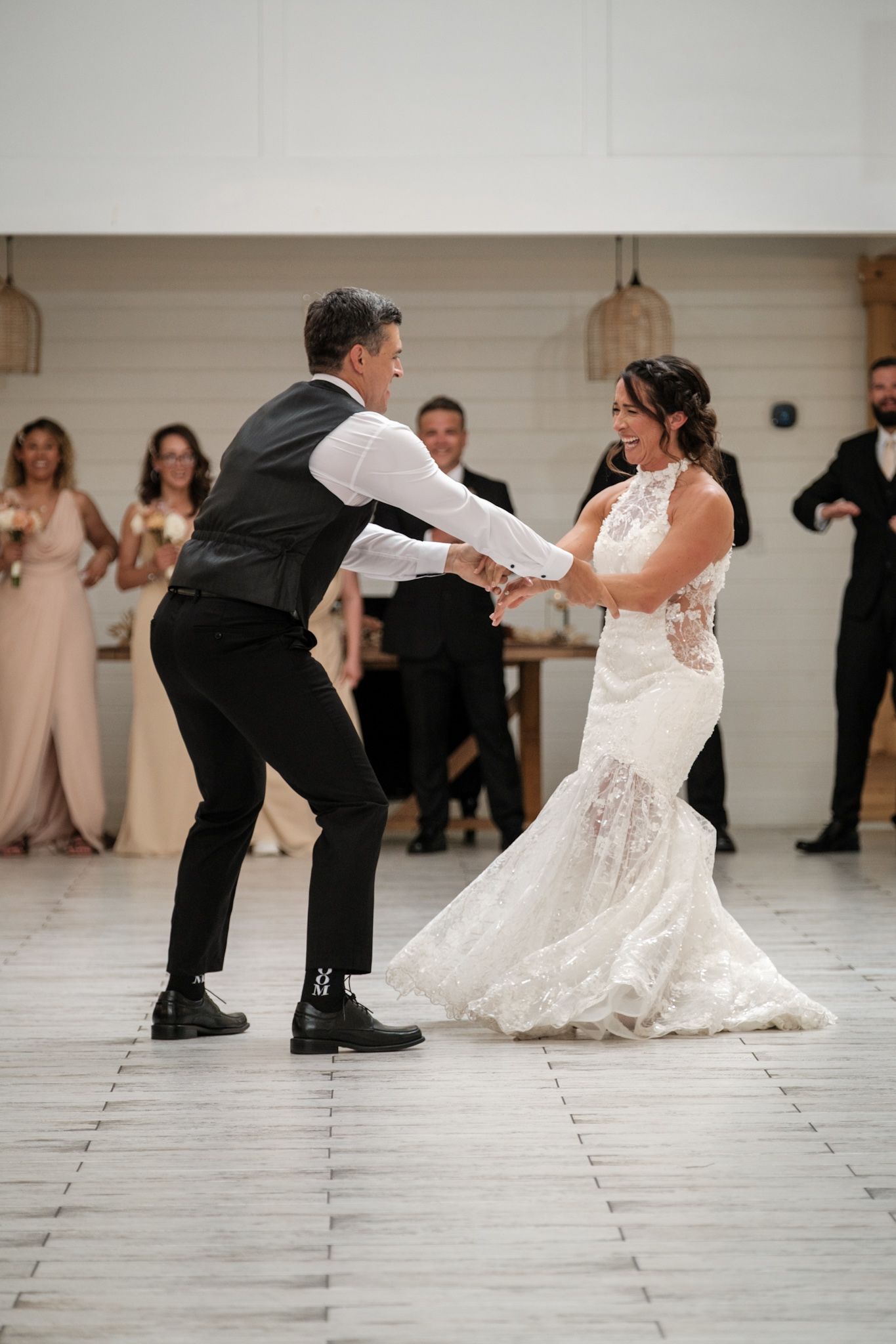 A series of photos showing a wedding couple performing a unique dipping dance move sequence on a light-colored dance floor.