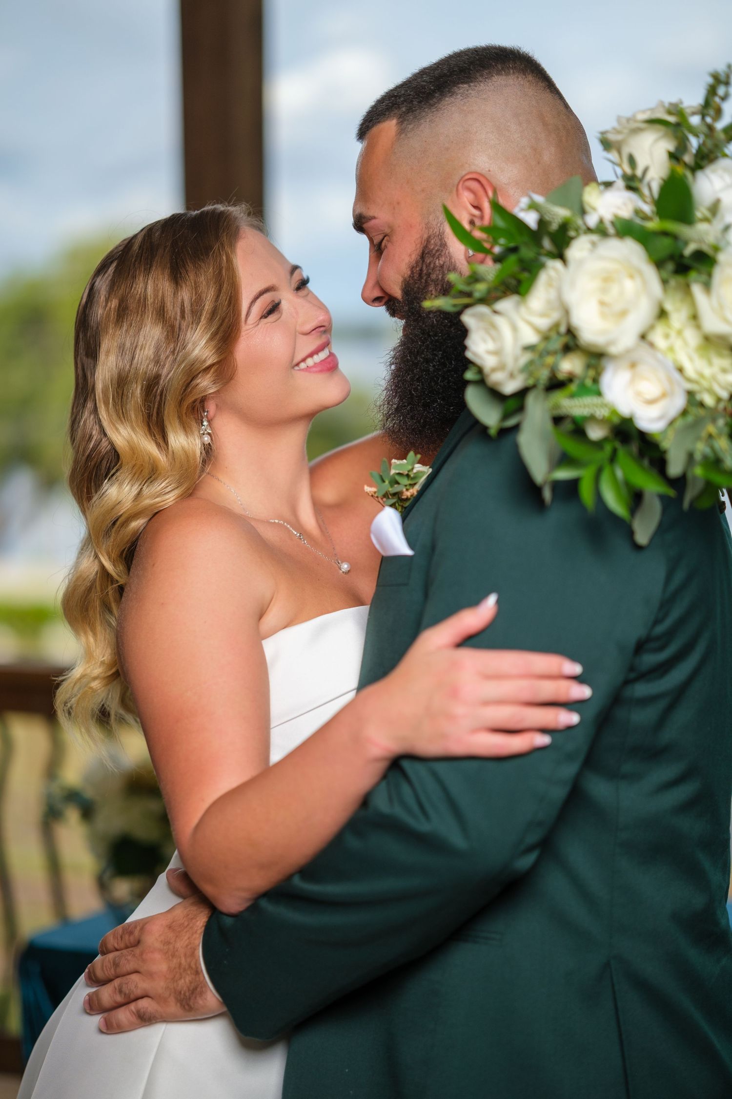 A happy couple shares intimate moments in a series of romantic wedding photos with white floral decorations.