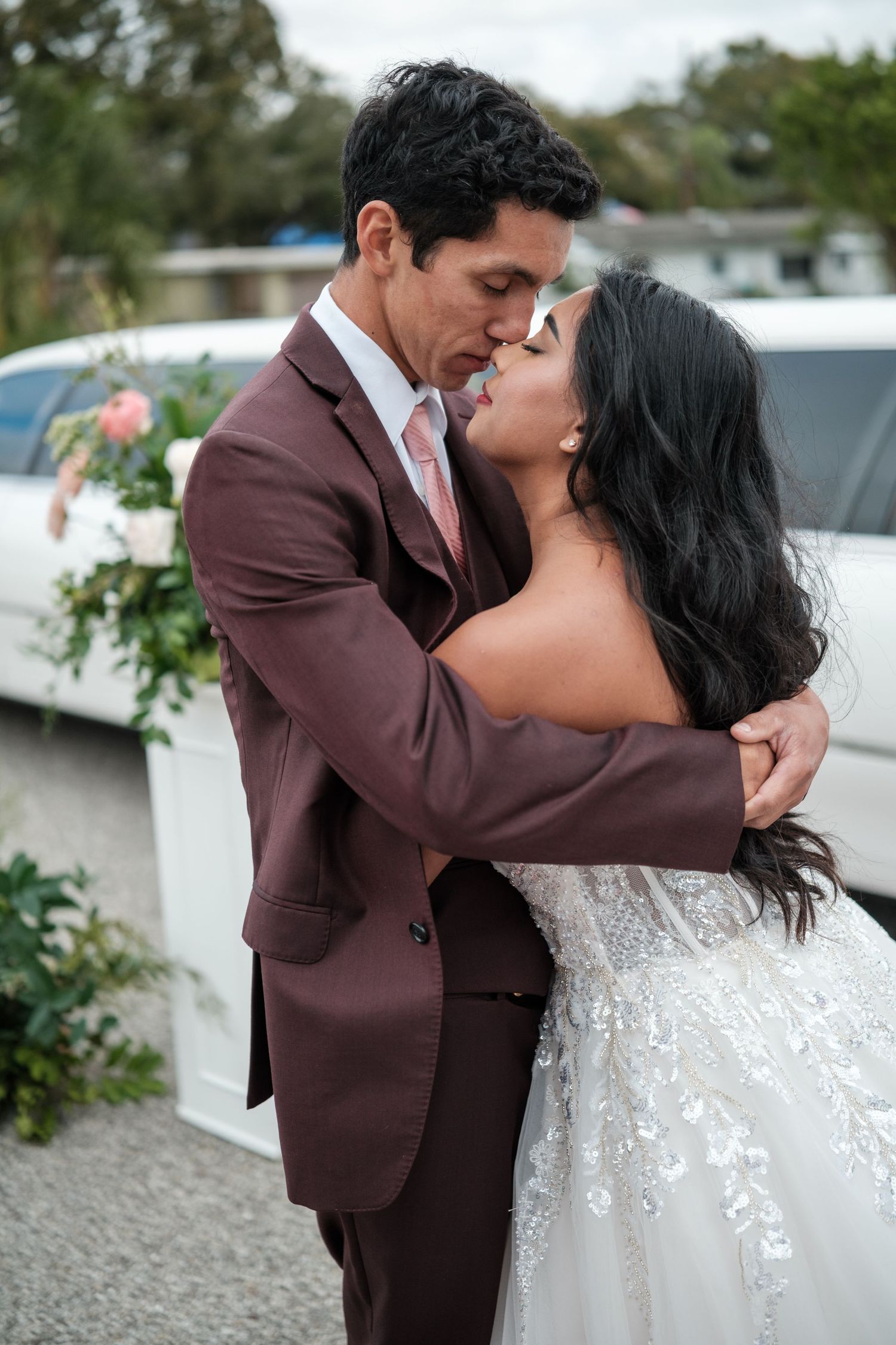 Intimate wedding portraits showing tender moments between newlyweds in a garden setting.