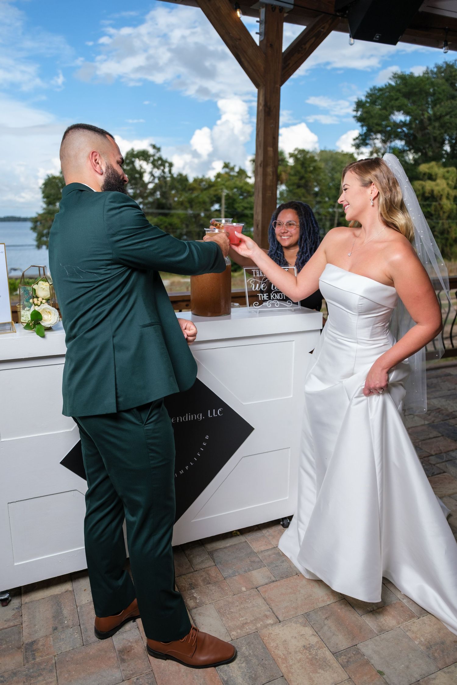 A sequence of photos showing a couple dancing together at a wedding reception on a stone patio.
