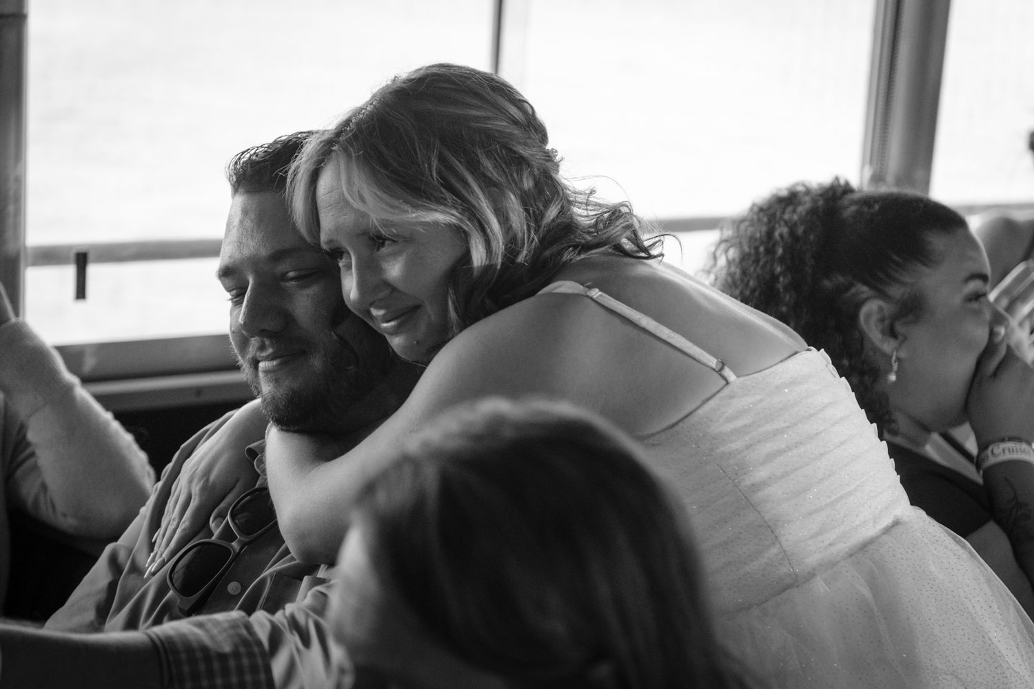 Black and white candid photo of wedding guests during a celebration.