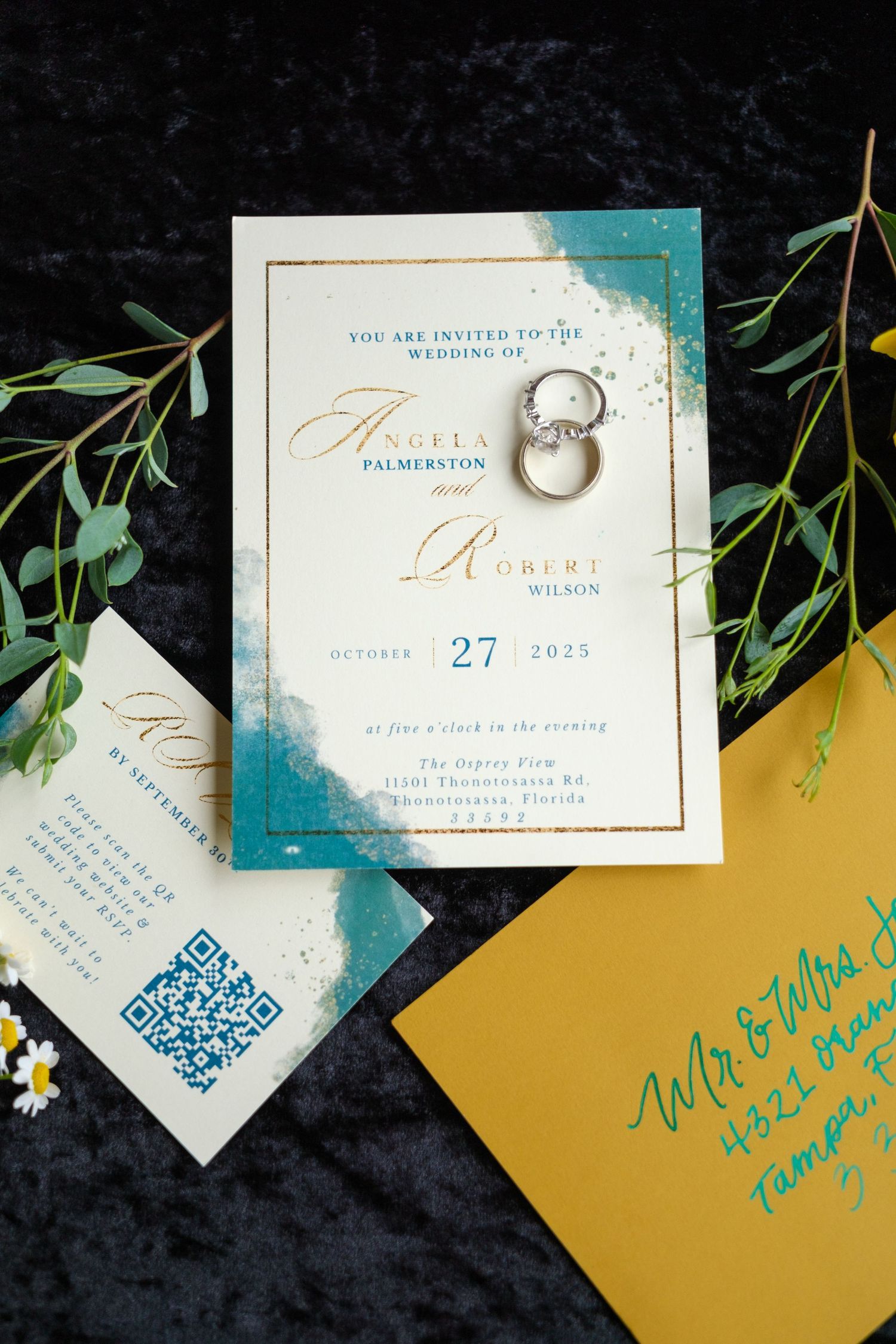 Wedding invitation suite featuring gold envelopes and turquoise accents with elegant calligraphy and a QR code detail.