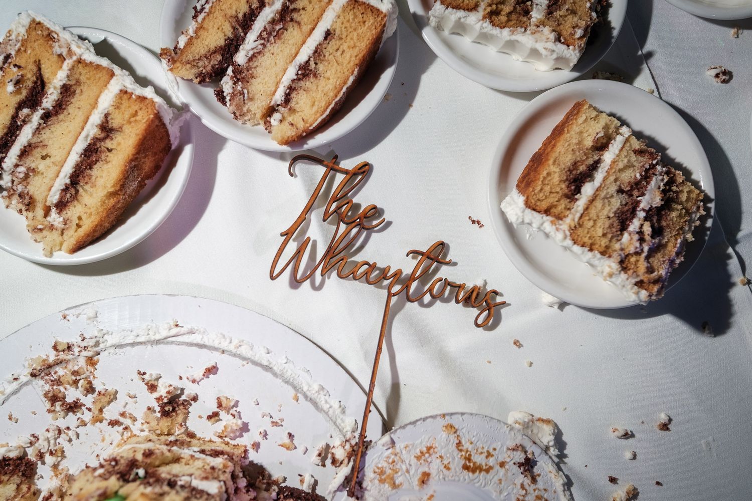 Close-up shots of sliced wedding cake pieces on white plates with chocolate drizzle.