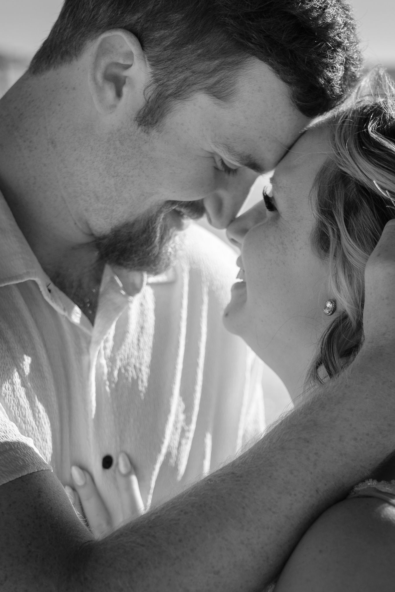 Intimate black and white portrait of a couple sharing a romantic moment together.