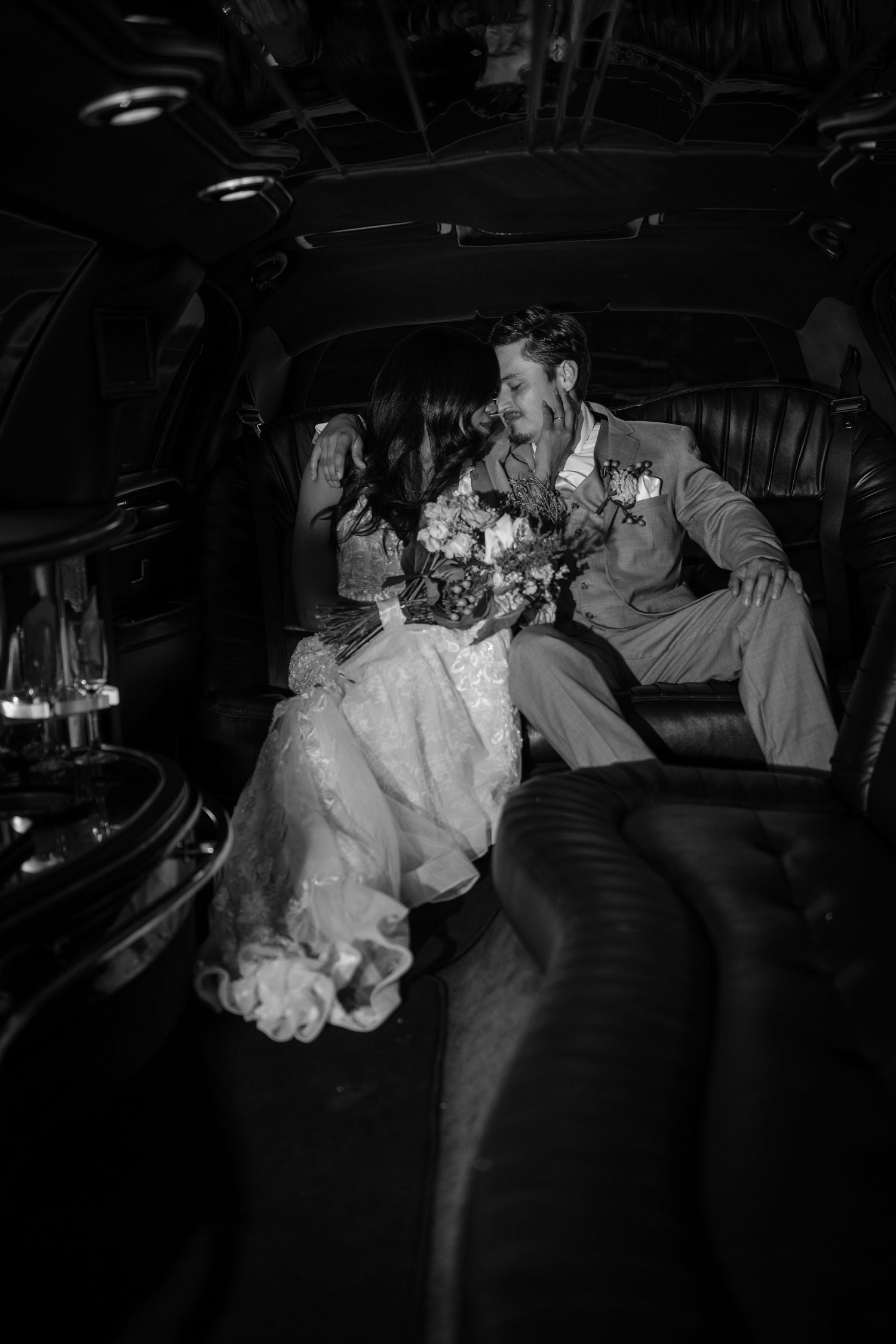 A romantic black and white photo sequence shows a couple in a vintage car sharing an intimate moment at night.