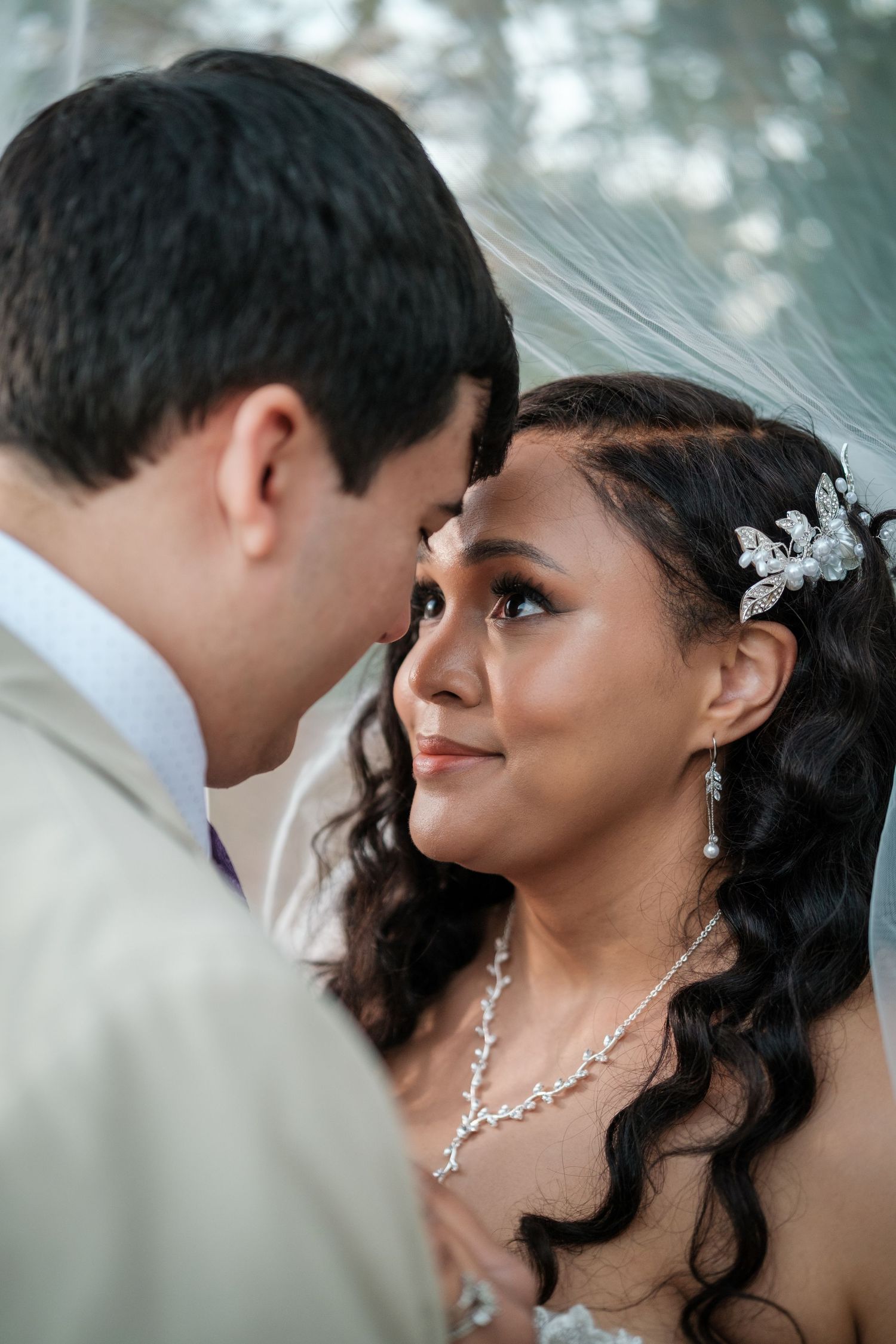 A romantic wedding couple shares intimate moments in a series of close-up portraits with elegant bridal jewelry.
