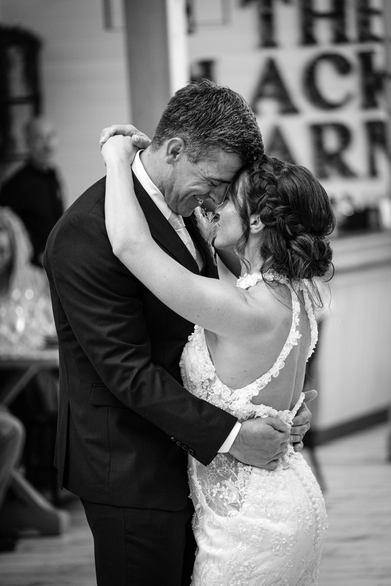 A romantic series of black and white wedding dance photos showing a couple in an intimate dip pose.