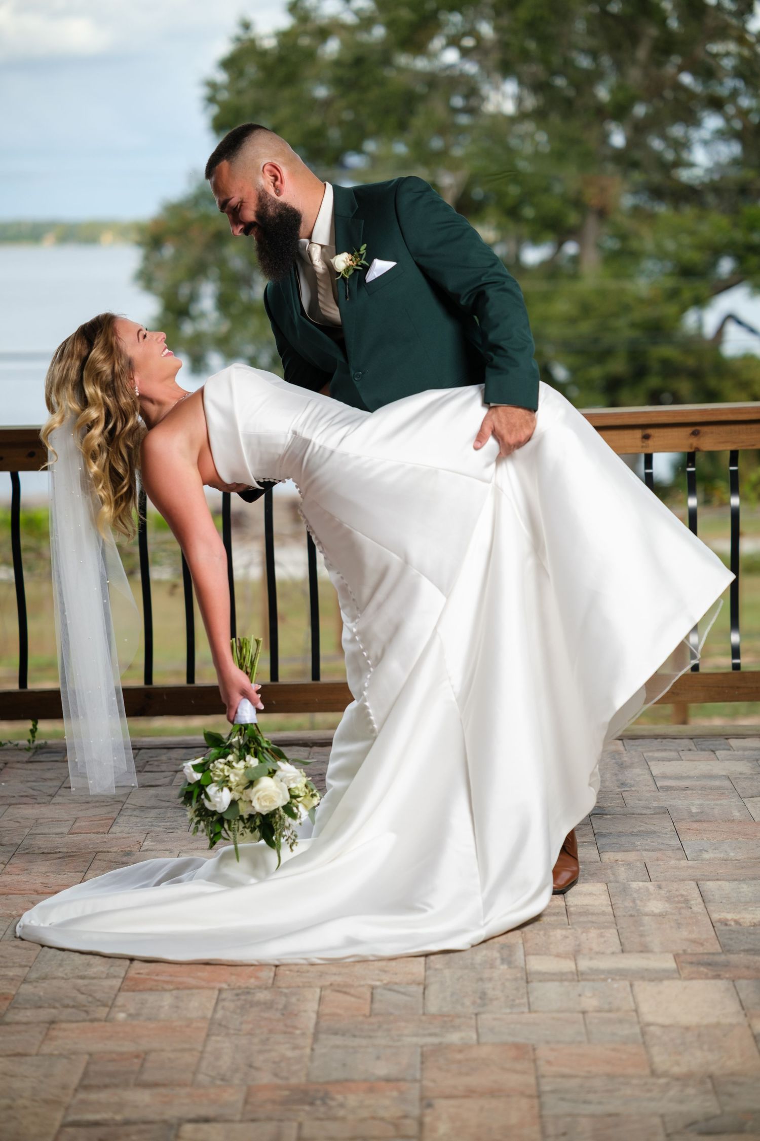 Sequence of romantic dip poses on an outdoor patio during a wedding celebration.