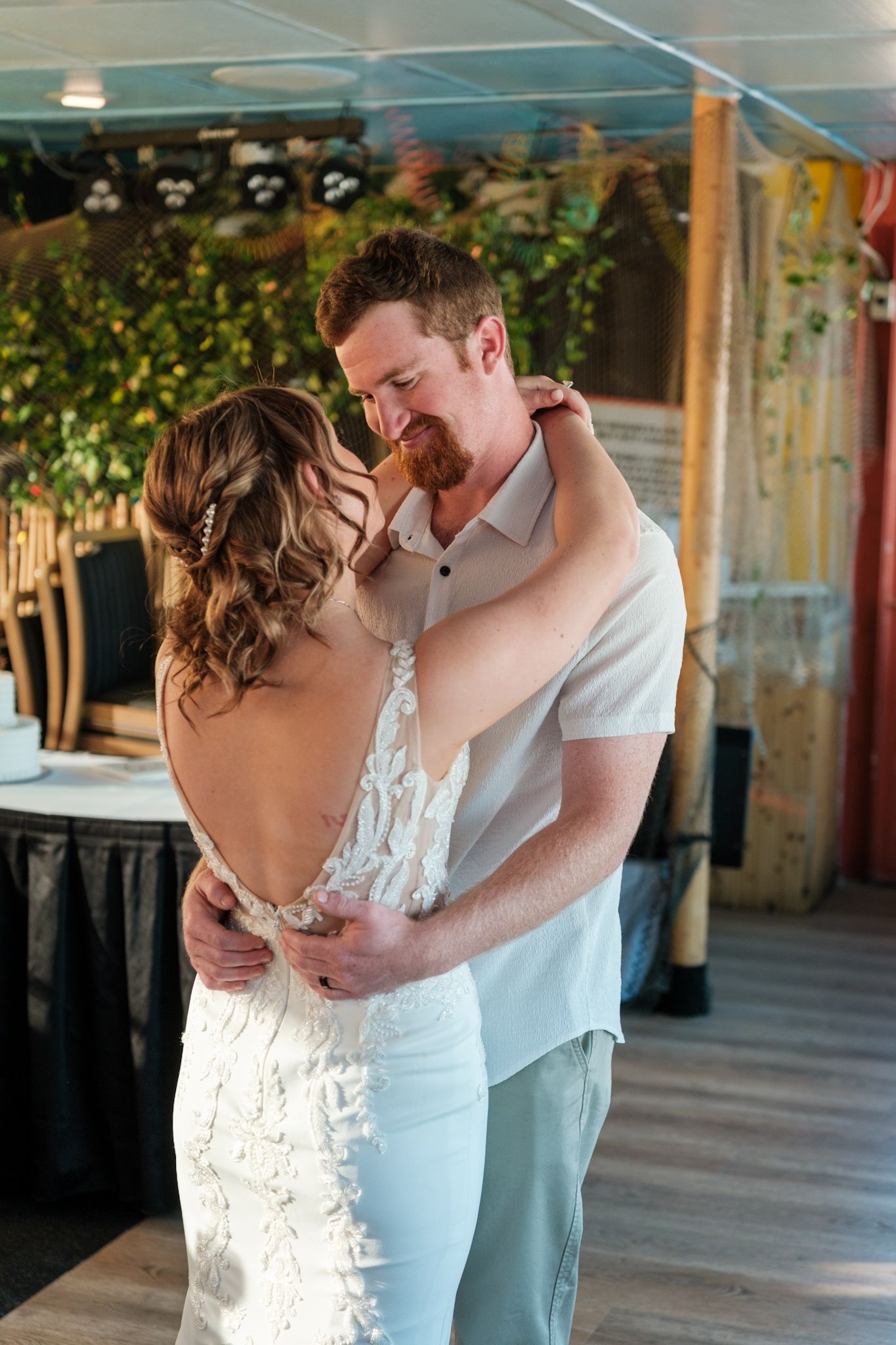 A romantic first dance sequence showing a couple in an intimate embrace at their wedding reception.