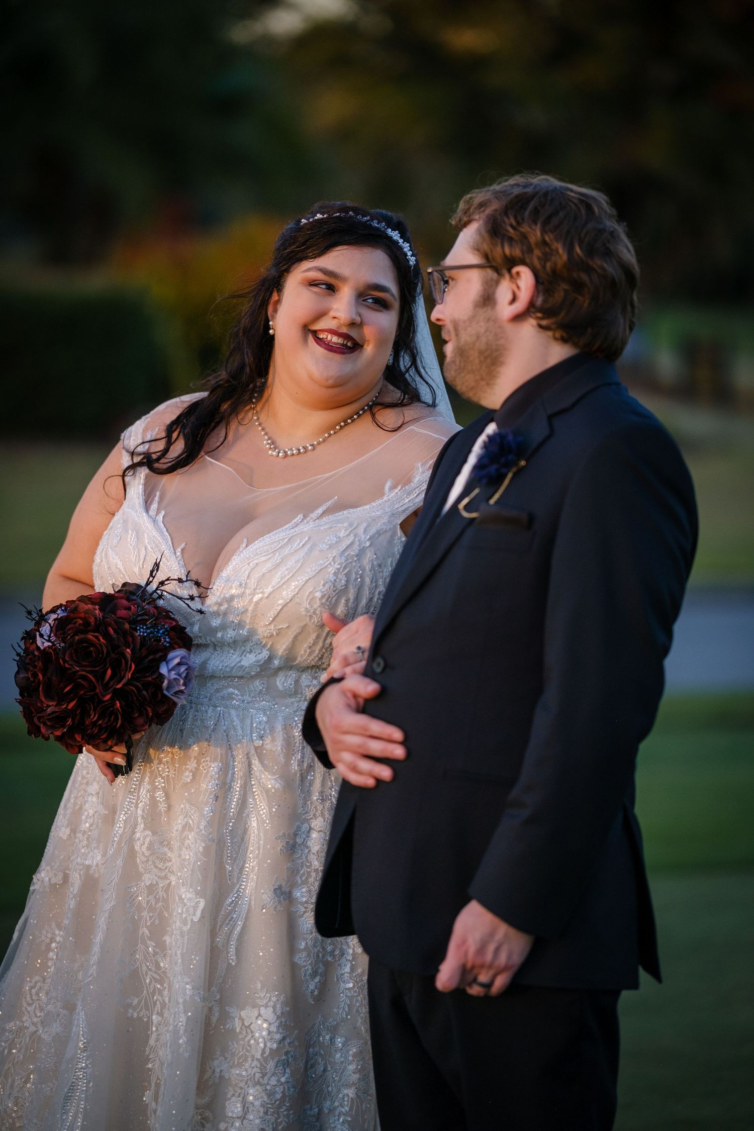 A romantic wedding couple embraces outdoors in a series of intimate poses at sunset.