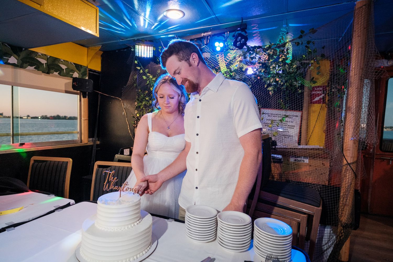 Wedding reception photos in rustic indoor venue with blue lighting and wooden decor.