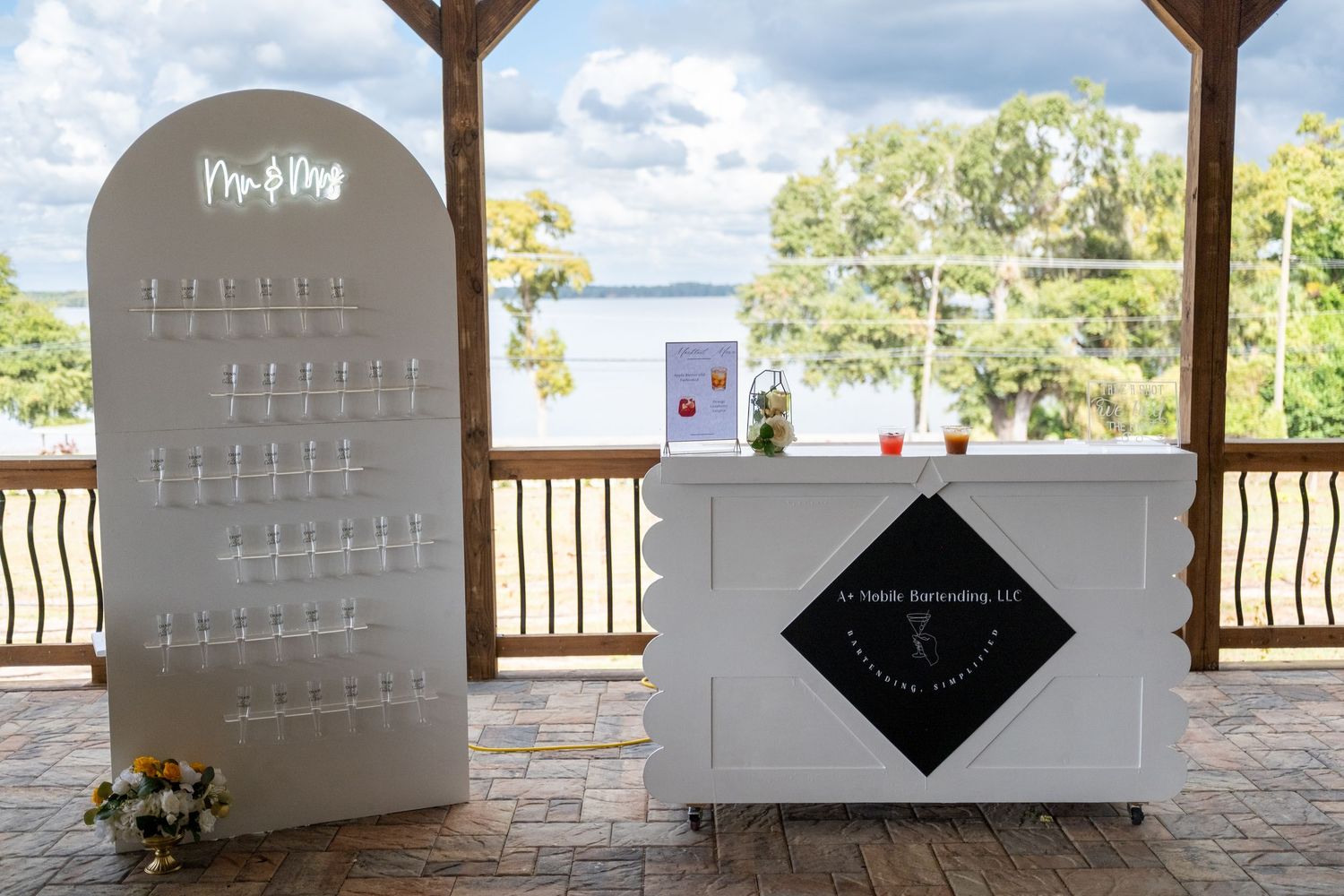 A series of calendar pages displayed on a wooden shelf with a blurred outdoor background.