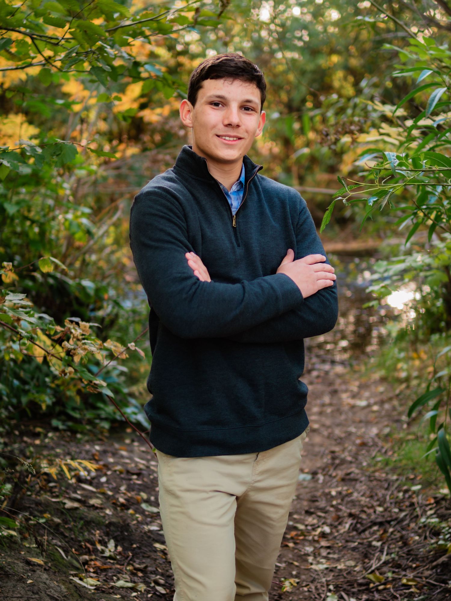 Outdoor portrait with natural autumn scenery and warm lighting.