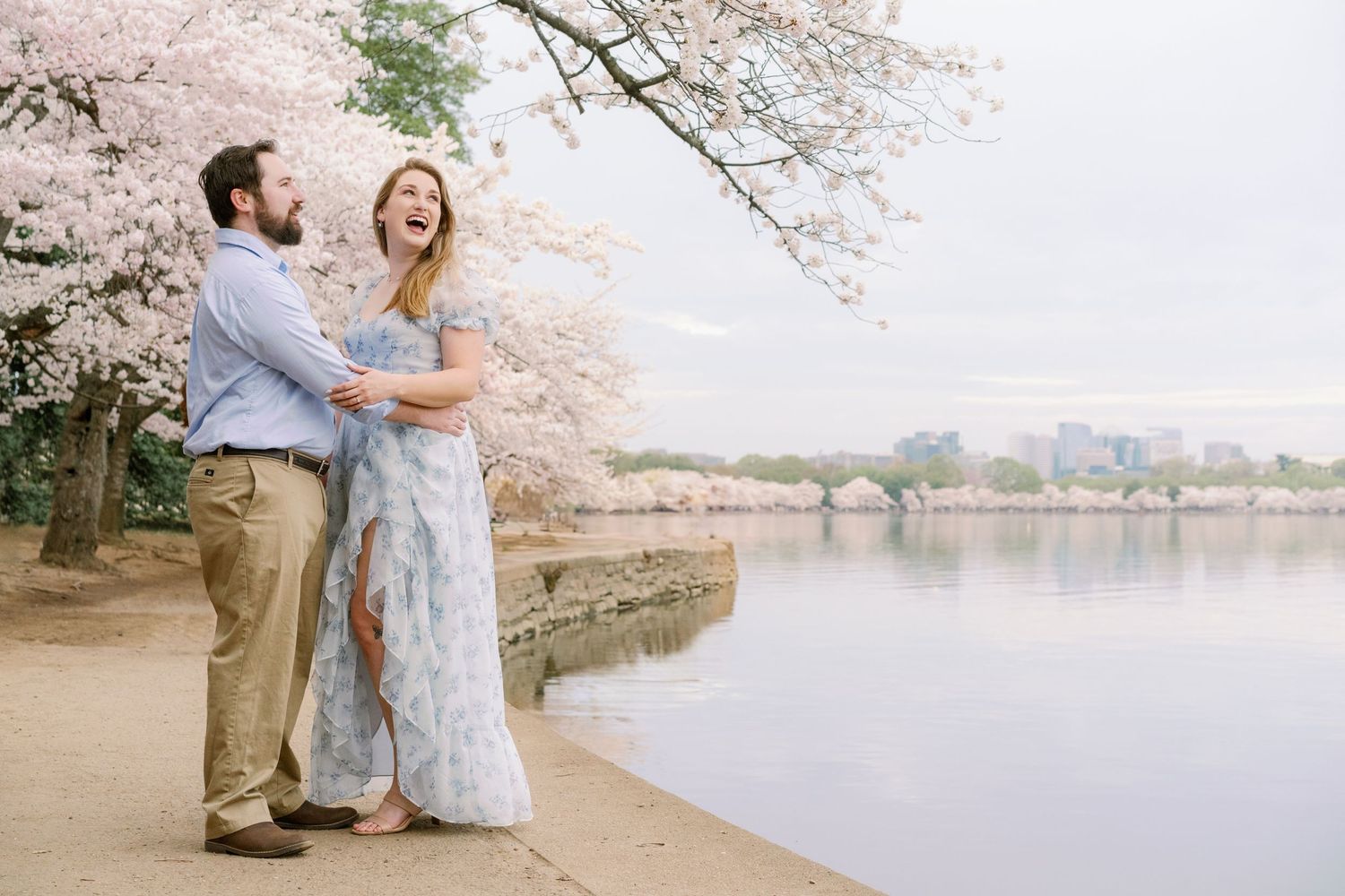 A loving moment captured beneath blooming cherry trees at the Tidal Basin.