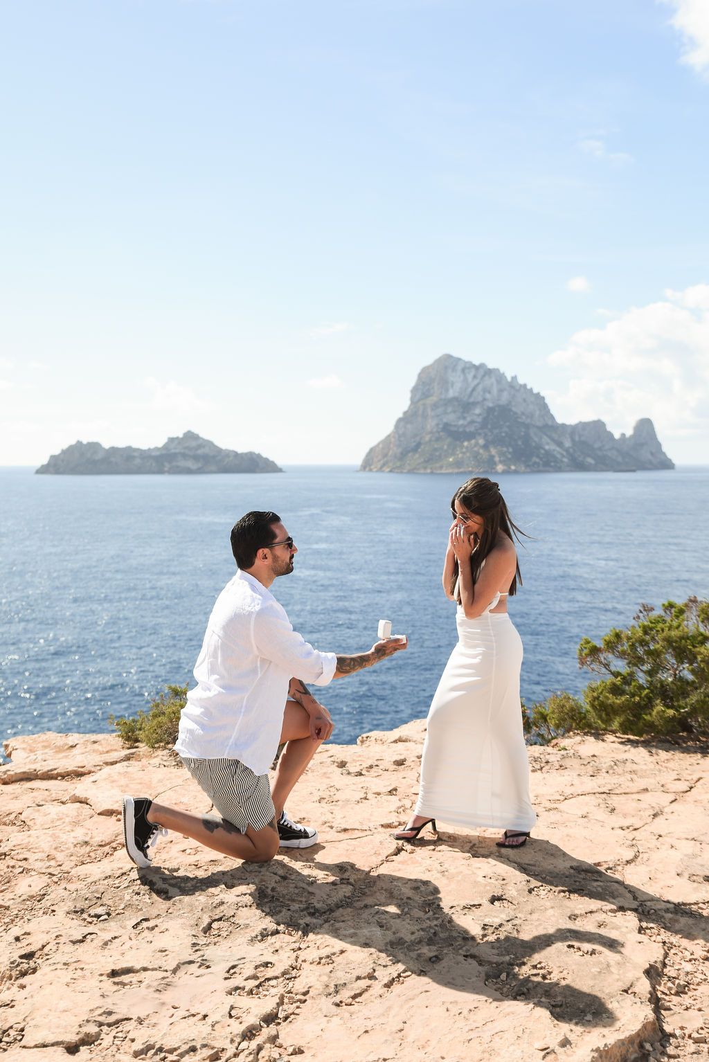 Ibiza surprise proposal photographer, couple proposing on a cliff with Es Vedra views