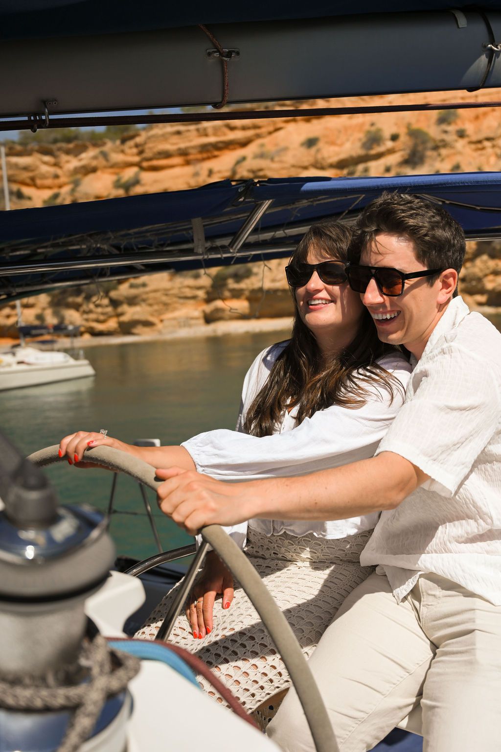 A couple celebrating their engagement during a catamaran proposal in Ibiza.