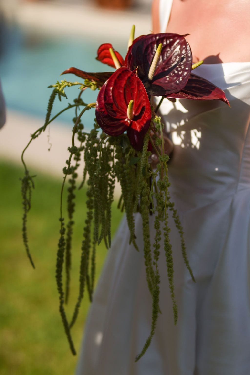 Bride holding a red flower bouquet at a wedding in Ibiza