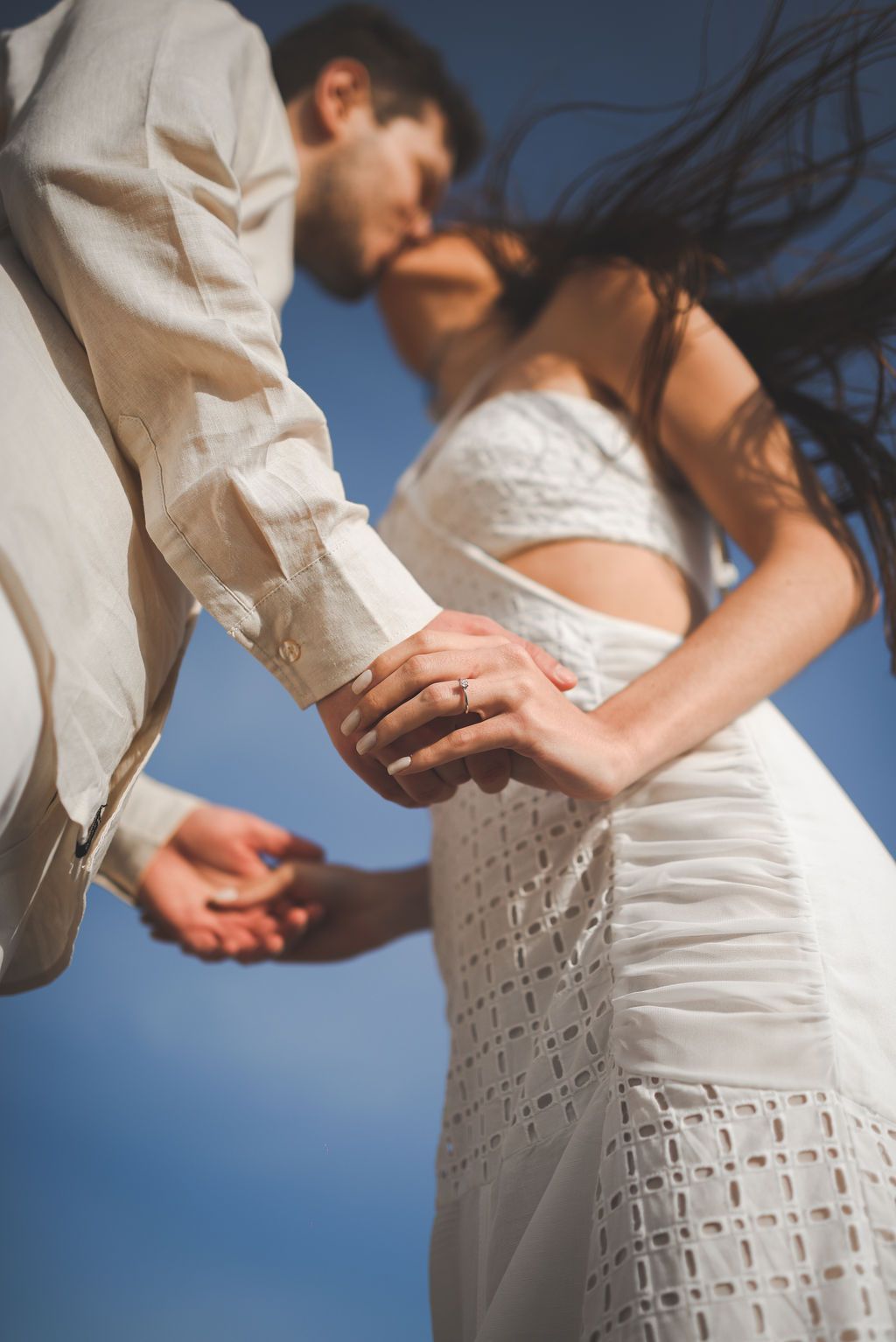 Editorial-style engagement photo of a couple in Ibiza, highlighting the engagement ring.