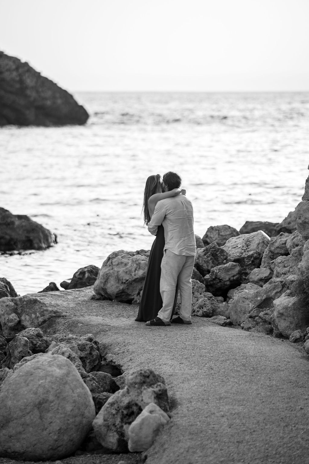 Engagement portraits of a couple after their surprise proposal at Cala Molí.