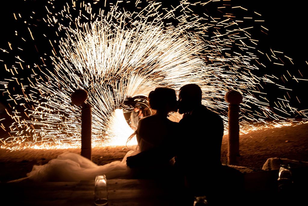 Elopement wedding party with fireworks at Alkamar Camp in the Agafay Desert, Morocco.