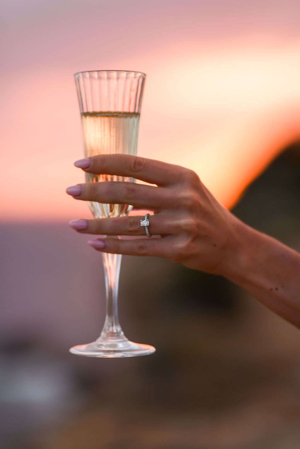 Ibiza proposal photographer, champagne toast detail with an engagement ring after a proposal.