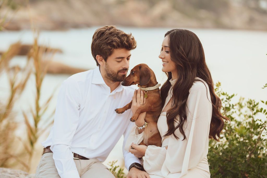 Couple with their dog during sunset engagement session at Cala Tarida Ibiza
