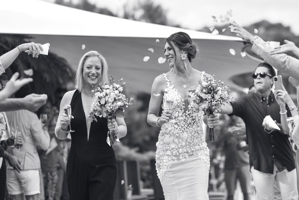 Bride and bride celebrating their beach wedding in Ibiza.