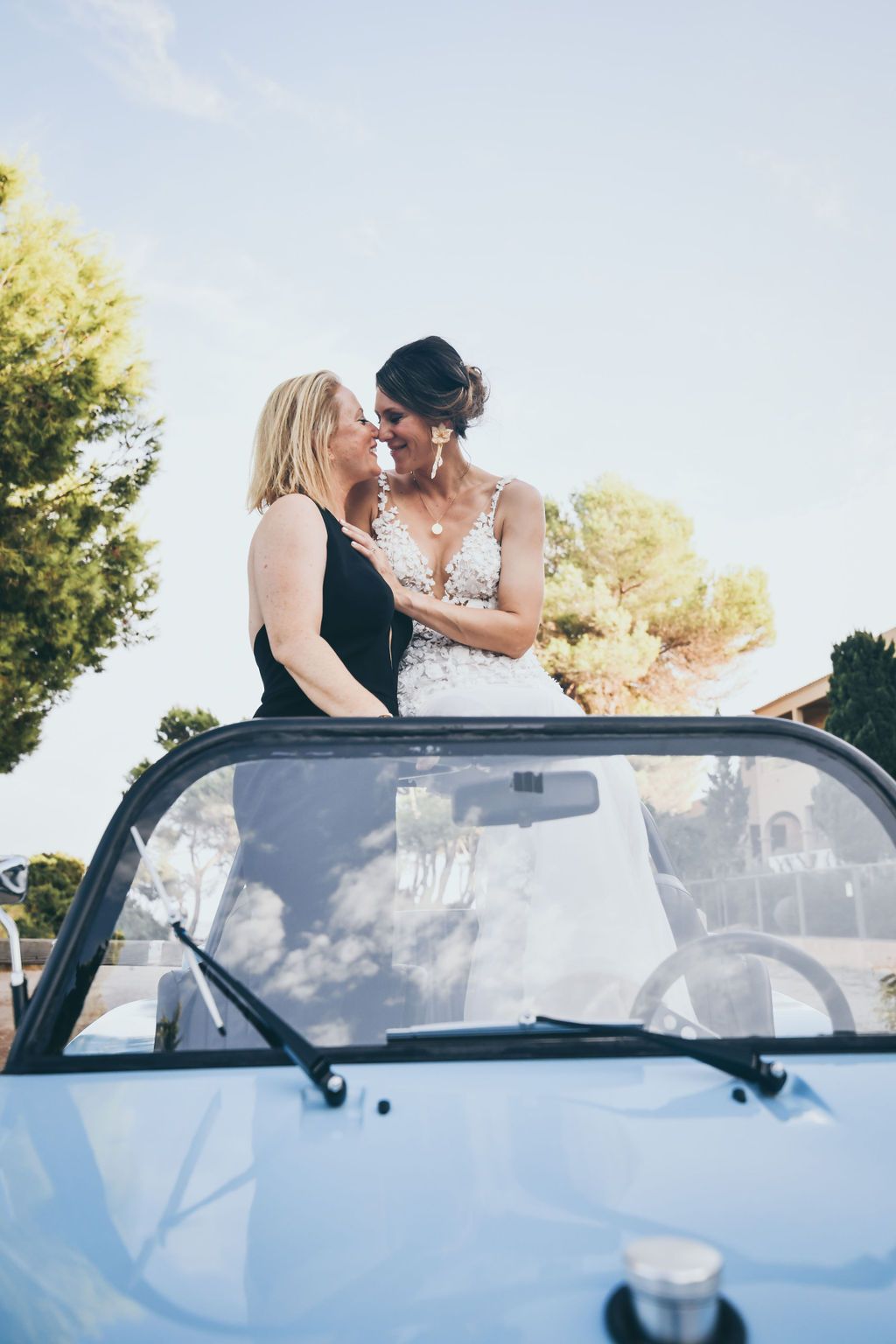 Bride and bride arriving by buggy car at their wedding at Babylon Beach Ibiza.