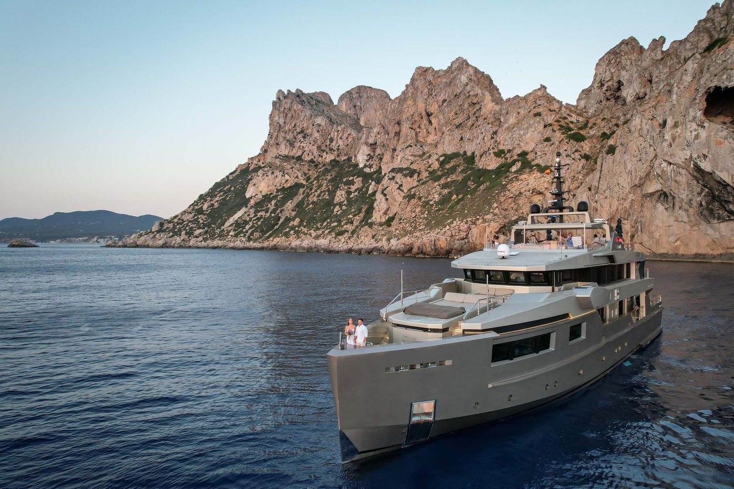 Drone view of bride and groom eloping on a luxury yacht with Es Vedra in the background, Ibiza.