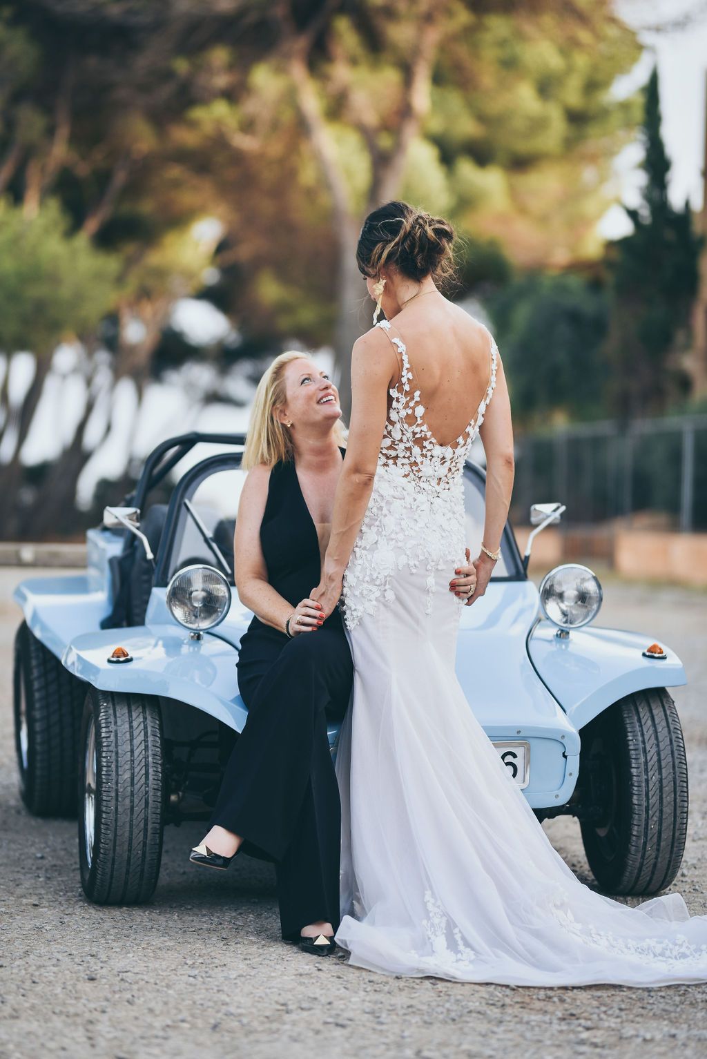 Bride and bride arriving by buggy car at their wedding at Babylon Beach Ibiza.