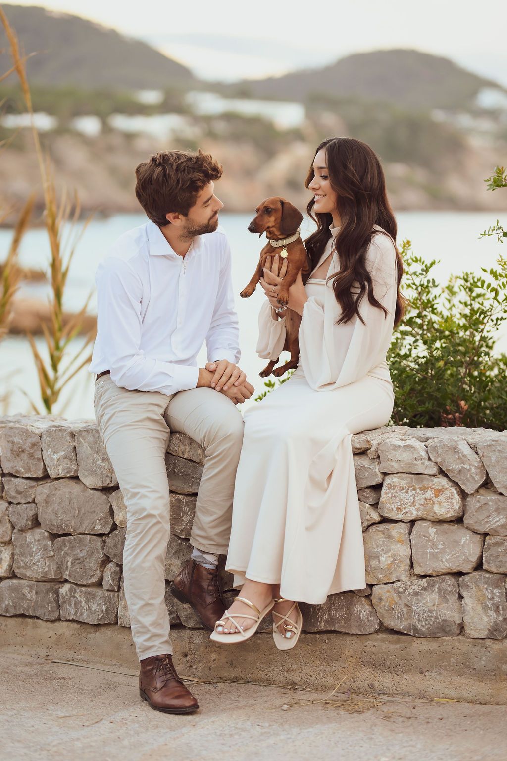 Couple cuddling with their dog during beach photoshoot in Ibiza