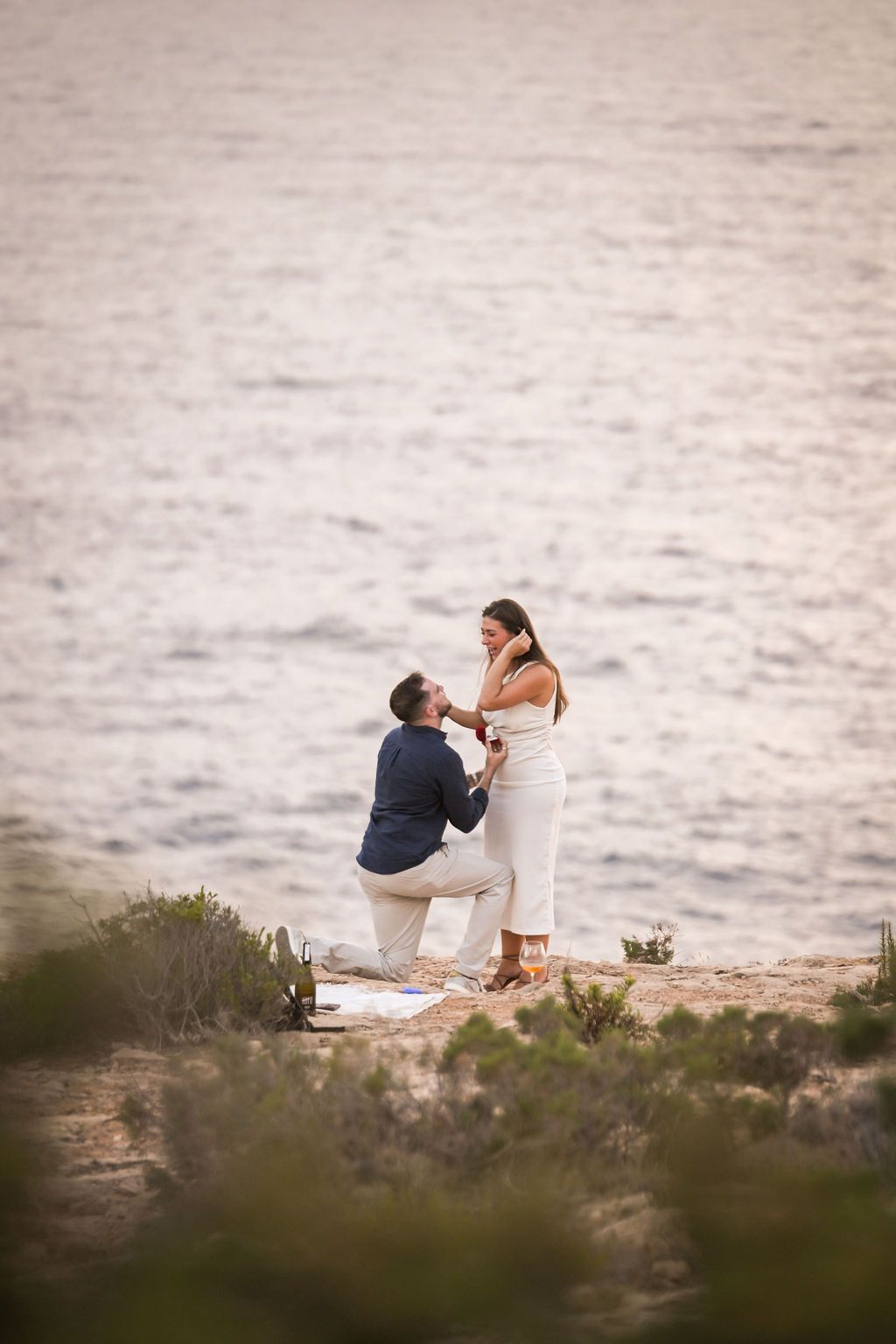 Surprise marriage proposal in Ibiza captured at Es Vedra with ocean views.